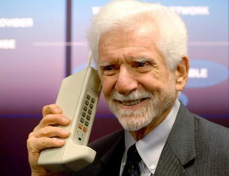 Inventor Martin Cooper holds one of the first mobile phones in this undated handout photo.